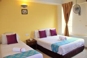 Postel nebo postele na pokoji v ubytování Sun Inns Hotel Puchong