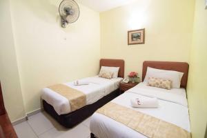 Postel nebo postele na pokoji v ubytování Sun Inns Hotel Puchong