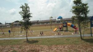 a playground with a slide in a park at Ainur Homestay in Kampung Sungai Baharu