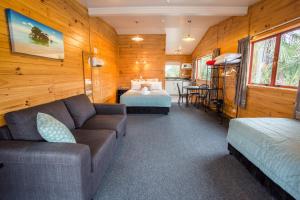 ein Wohnzimmer mit einem Sofa und einem Bett in der Unterkunft Nelson City TOP 10 Holiday Park in Nelson