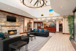 a lobby with couches and a fireplace in a store at Days Hotel by Wyndham Allentown Airport / Lehigh Valley in Allentown