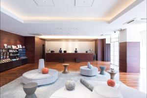 a lobby with two white chairs and a table at HOTEL MYSTAYS Kyoto Shijo in Kyoto