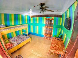a childs bedroom with colorful walls and a bunk bed at Tagaytay Bloom Breeze Cruz Apartelle in Tagaytay