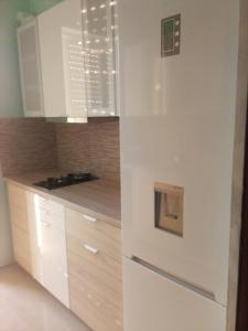 a kitchen with white cabinets and a counter top at Rafina Port Paradise in Rafina