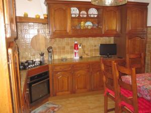 a kitchen with wooden cabinets and a counter top at Villa Pastriccialone in Afa