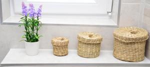 three baskets sitting on a counter next to a window at Apartman Bradasevic Tivat in Tivat
