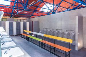a bathroom with a row of urinals and sinks at Camping Santa Tecla in A Guarda +83 photos