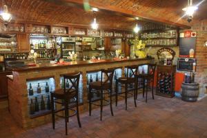 a bar with bar stools in a room at Penzion u Čápa Příbor in Příbor