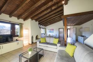 a living room with a couch and a tv at Centro Cadro Panoramica in Lugano