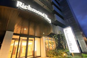 a building with a sign in front of it at Richmond Hotel Higashi Osaka in Osaka
