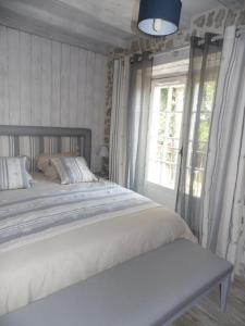 a bed in a room with a window and a bed sidx sidx at Gite STANDING climatisé avec piscine chauffée et SPA PRIVATIF in Alzonne +41 photos