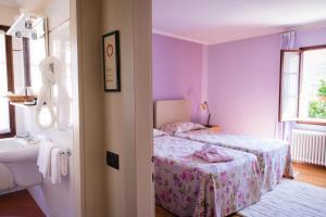 Postel nebo postele na pokoji v ubytování Locanda Solagna