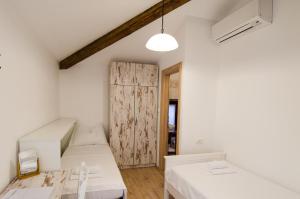 una piccola stanza con due letti e un tavolo di Casa Rossa Motovun a Motovun (Montona)