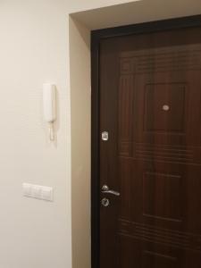 une porte dans une pièce avec un téléphone sur le mur dans l'établissement Boatman's harbor, à Liepāja