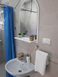 a bathroom with a sink and a mirror at Strandhaus Adria in Ulcinj