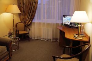 a hotel room with a desk with a computer on it at Sadko Hotel in Velikiy Novgorod