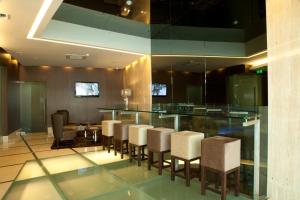 a room with a bar with chairs and a table at TURIM Luxe Hotel in Lisbon