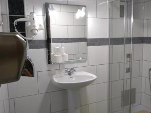 a bathroom with a sink and a mirror at Hostel Nature in Zambujeira do Mar +37 photos