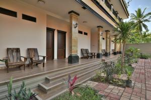 a porch of a house with chairs and plants at Saka Boutique Hotel in Nusa Penida