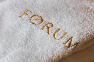 
a white towel on top of a white towel at Forum Boutique Hotel & Spa - Adults Only in Alcudia
