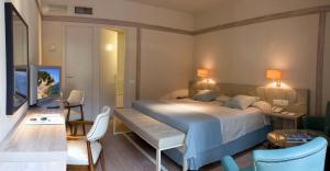 a bedroom with a bed and a table and chairs at Hotel Santa Marta in Lloret de Mar