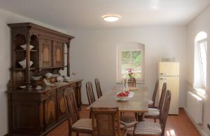a kitchen with a table with chairs and a refrigerator at Ferienheim Kuckuckswinkel in Schöna