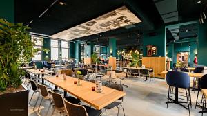 
a restaurant with tables, chairs, and tables at Conscious Hotel Westerpark in Amsterdam
