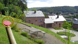 a bench on a hill in front of a building at L'Oree De Bomal in Durbuy