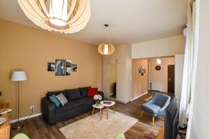 a living room with a couch and a chair at Christine Apartment close to the Buda Castle in Budapest