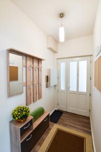 a hallway with a bench and a door with a mirror at Christine Apartment close to the Buda Castle in Budapest