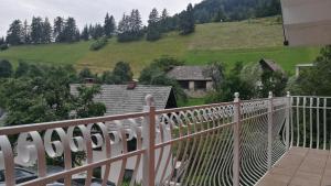 a balcony of a house with a view of a hill at House of relaxation in Zgornja Sorica