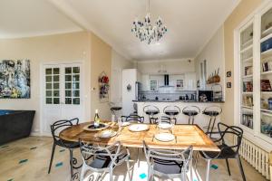 a dining room with a wooden table and chairs at Villa Dracoena in Nice