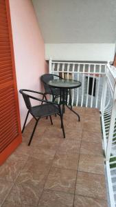 a small table and a chair on a balcony at House of relaxation in Zgornja Sorica