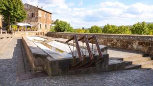 a metal bench with stairs in front of a building at La Casetta ai Lavatoi di Sutri in Sutri