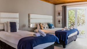 Ένα ή περισσότερα κρεβάτια σε δωμάτιο στο Out of Africa Guesthouse