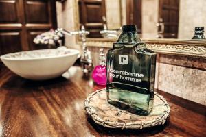 a bottle of alcohol sitting on a table in a bathroom at Rigat Park & Spa Hotel - Adults Recommended in Lloret de Mar