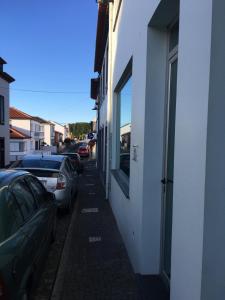 a street with cars parked on the side of a building at Santa Cruz Flat - Alojamento Local in Praia da Vitória