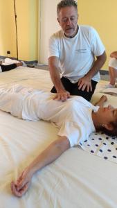 a man is helping a woman on a bed at B&B Mulini Venturi in Saludecio