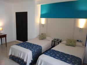 Posteľ alebo postele v izbe v ubytovaní Hotel Nuevo Ara