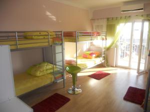 a room with two bunk beds and a stool in it at Backpackers Fairytale Hostel in Split