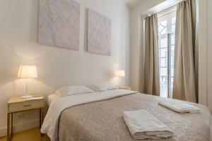 une chambre avec un lit avec deux serviettes dessus dans l'établissement Santa Justa Prime Guesthouse, à Lisbonne