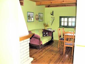 a bedroom with a bed and a table and chairs at Agroturystyka Szafarnia 19 in Kurzętnik