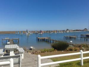 a dock with sailboats in the water with boats at Rivertides Self Catering Guest House in Velddrif