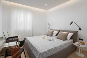a bedroom with a bed and a table and a desk at Apartment Fianona - Rovinj city center in Rovinj