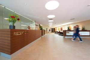 a lobby with a reception desk in a building at Sternen Hotel Wolfurt in Bregenz