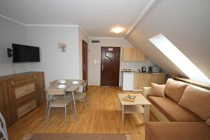 a living room with a couch and a table at Apartamenty Olsztyn in Olsztyn