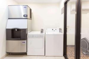 a small kitchen with a stove and a refrigerator at Super 8 by Wyndham Decatur/Dntn/Atlanta Area in Decatur