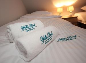 a pile of towels on a bed in a hotel room at Apartamenty Olsztyn in Olsztyn