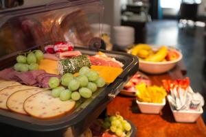 a tray of food with grapes and other foods on a table at Georgian House & Mews in York