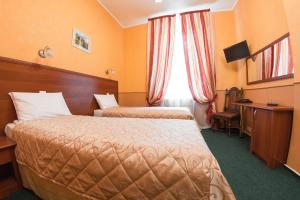 Кровать или кровати в номере Гостиница Империя парк